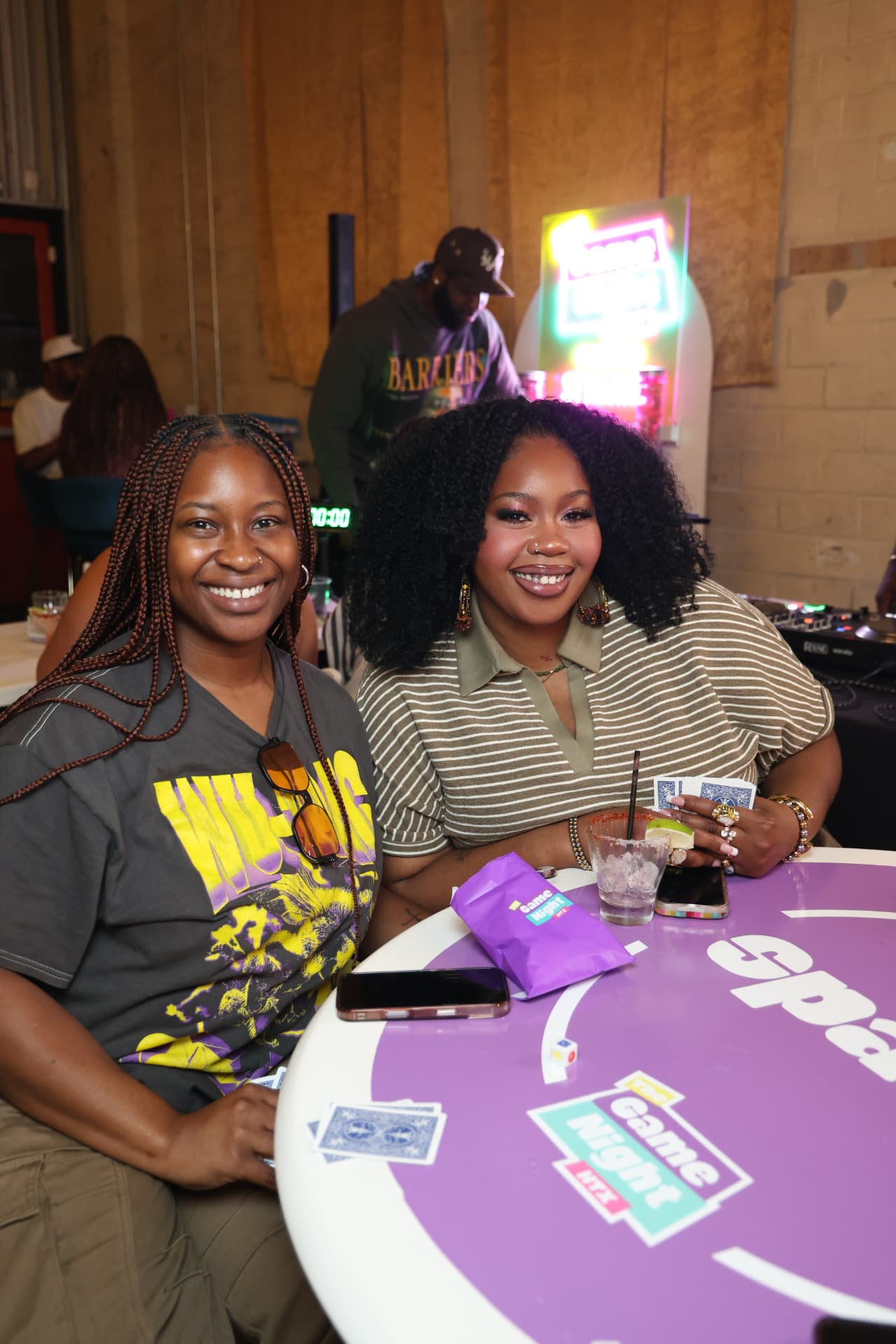Two guests playing Spades at a purple game table