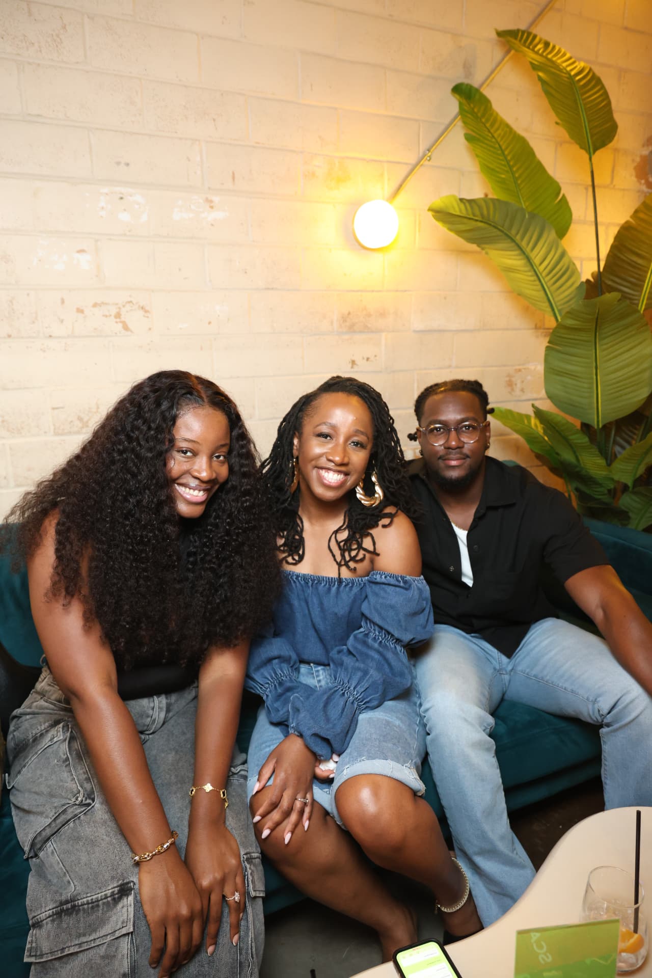 Three friends hanging out together on a couch