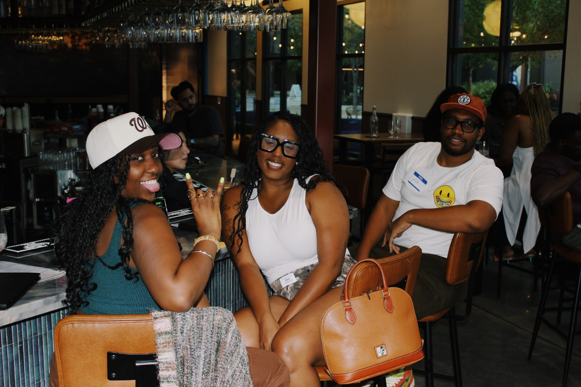 Guests laughing at the bar with name tags on